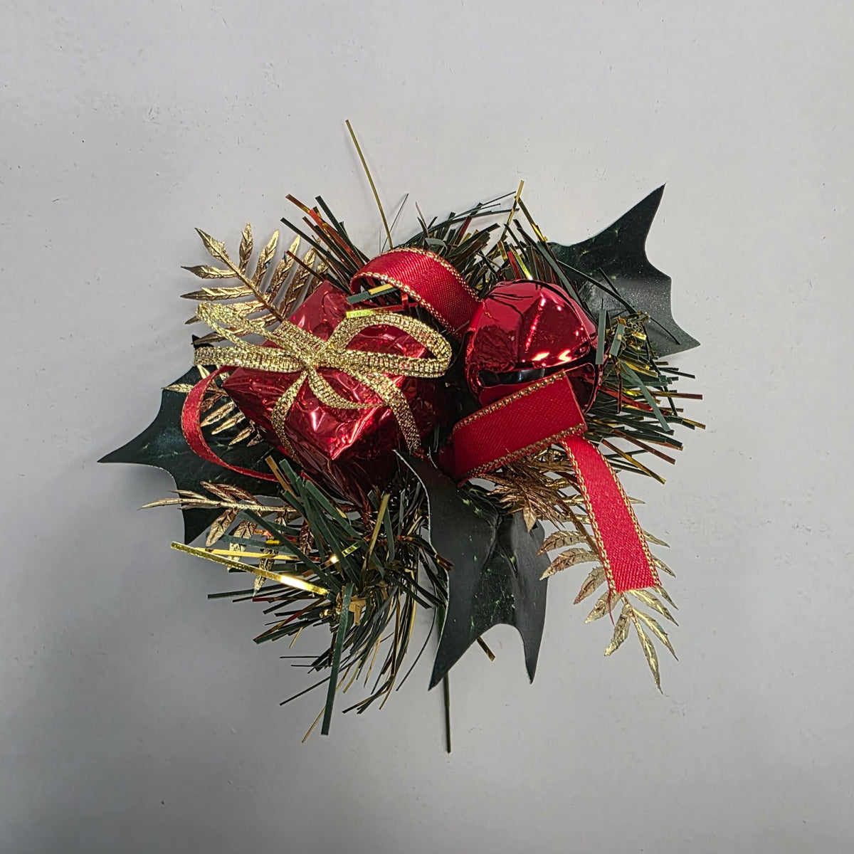 Red and gold Christmas decorative pick with gift parcel, bell and foliage