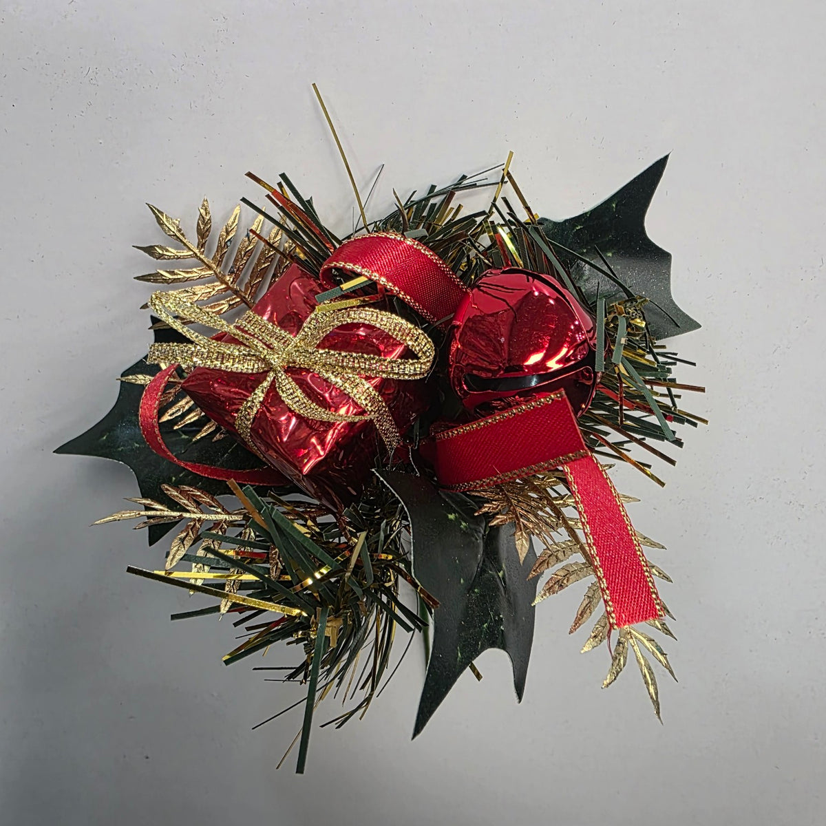 Red and gold Christmas decorative pick with gift parcel, bell and foliage