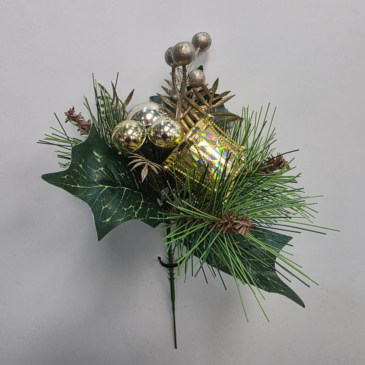 Green and gold Christmas decorative pick with bells and festive foliage