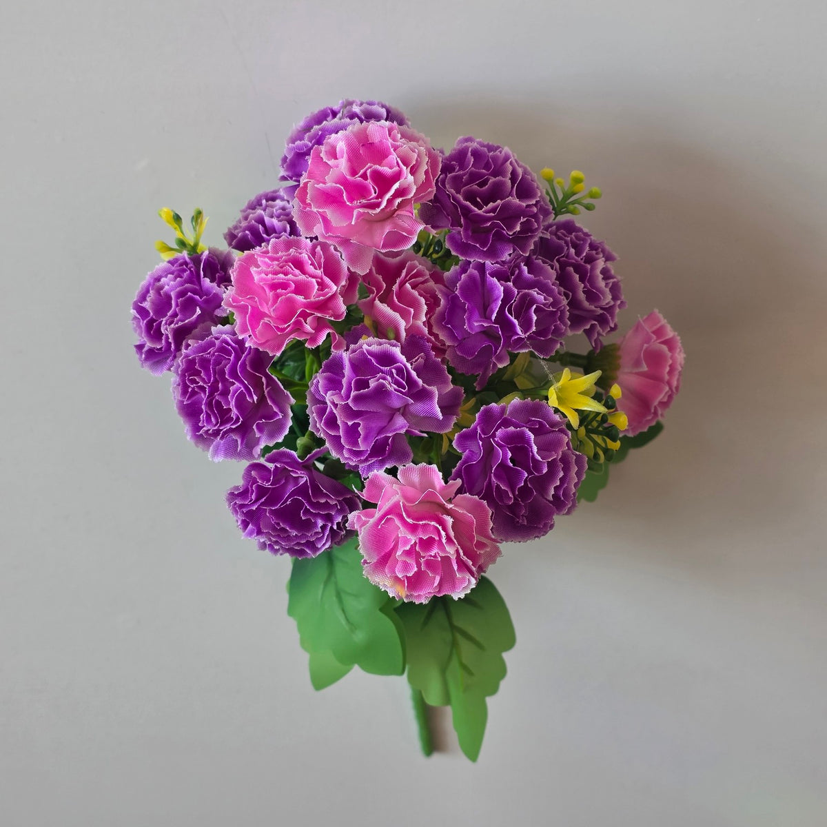 Purple artificial mini carnation flower bunch - close-up