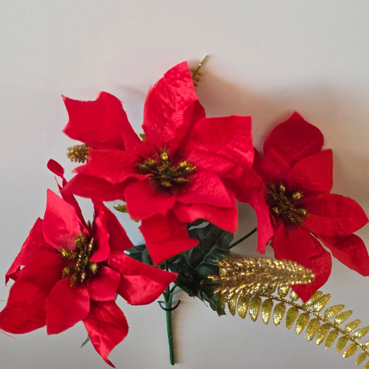 Red and gold sparkle artificial poinsettia Christmas flower